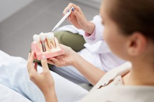 patient and dentist looking at tooth implant